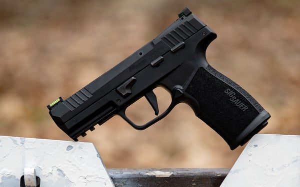 A handgun sitting on a target hanger.