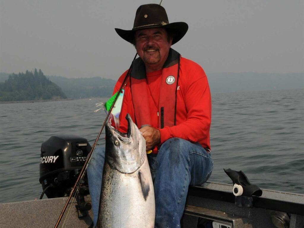 Buzz Ramsey in red shirt riding a horse