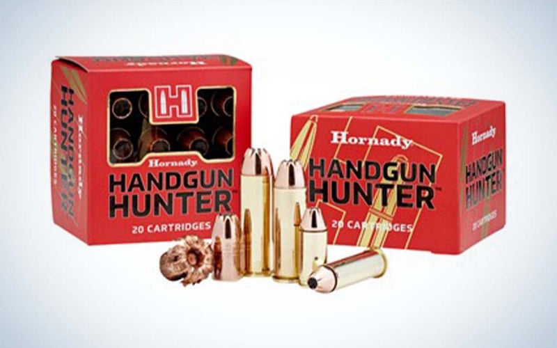 Two red boxes of best 10mm ammo behind a pile of gold bullets