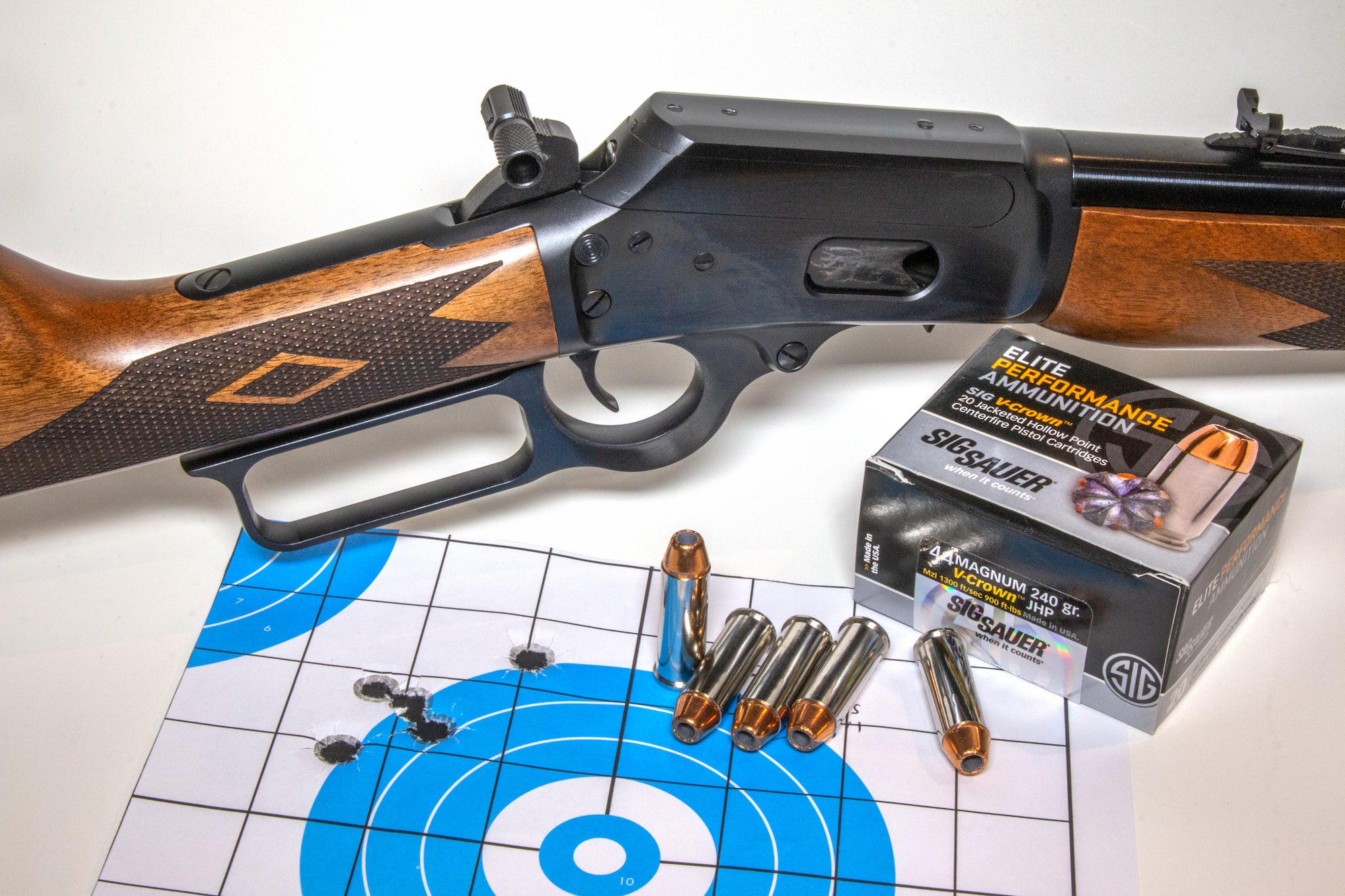 Rifle with ammo on a table.