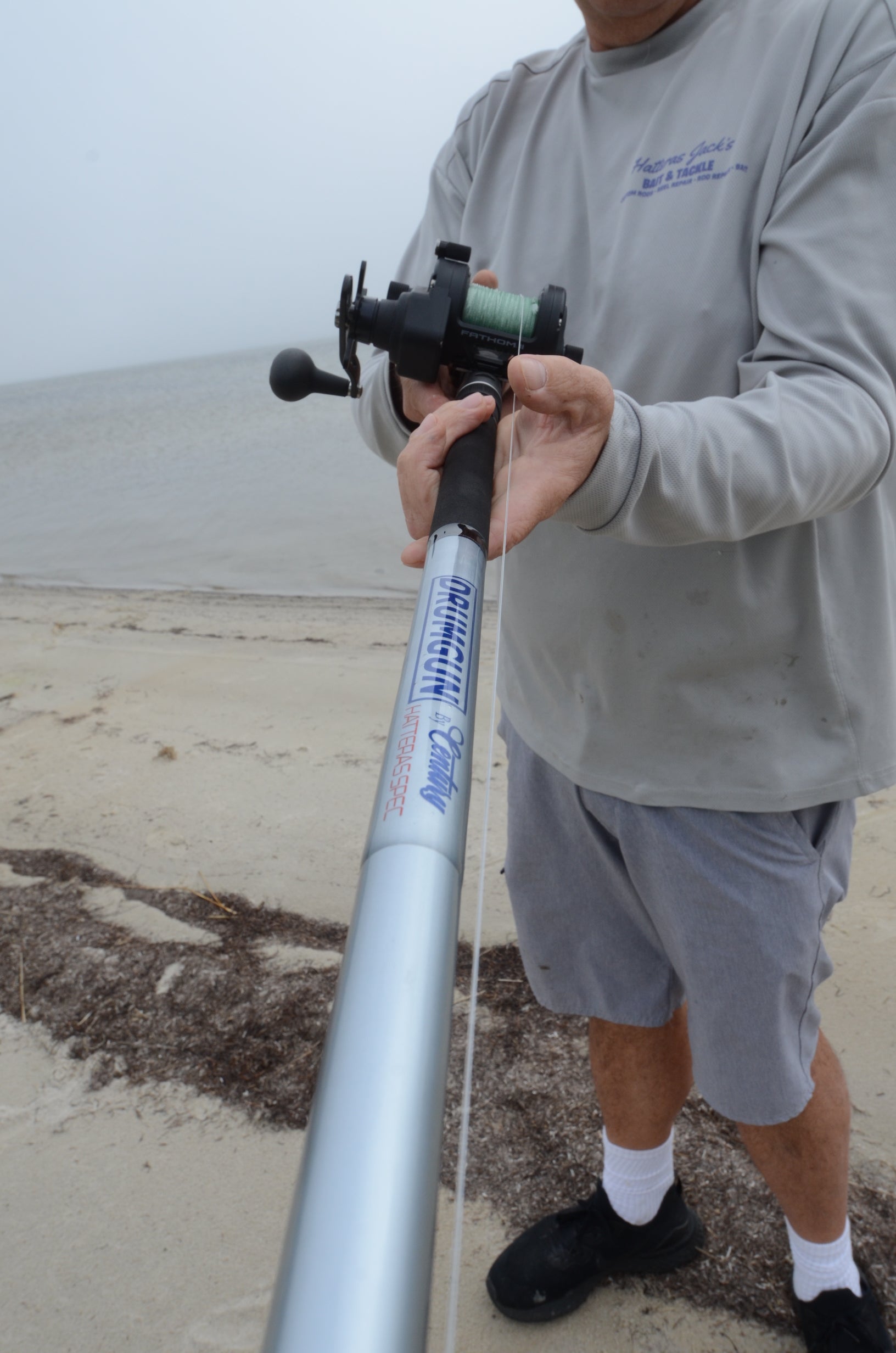 Angler holds the Drum Gun.