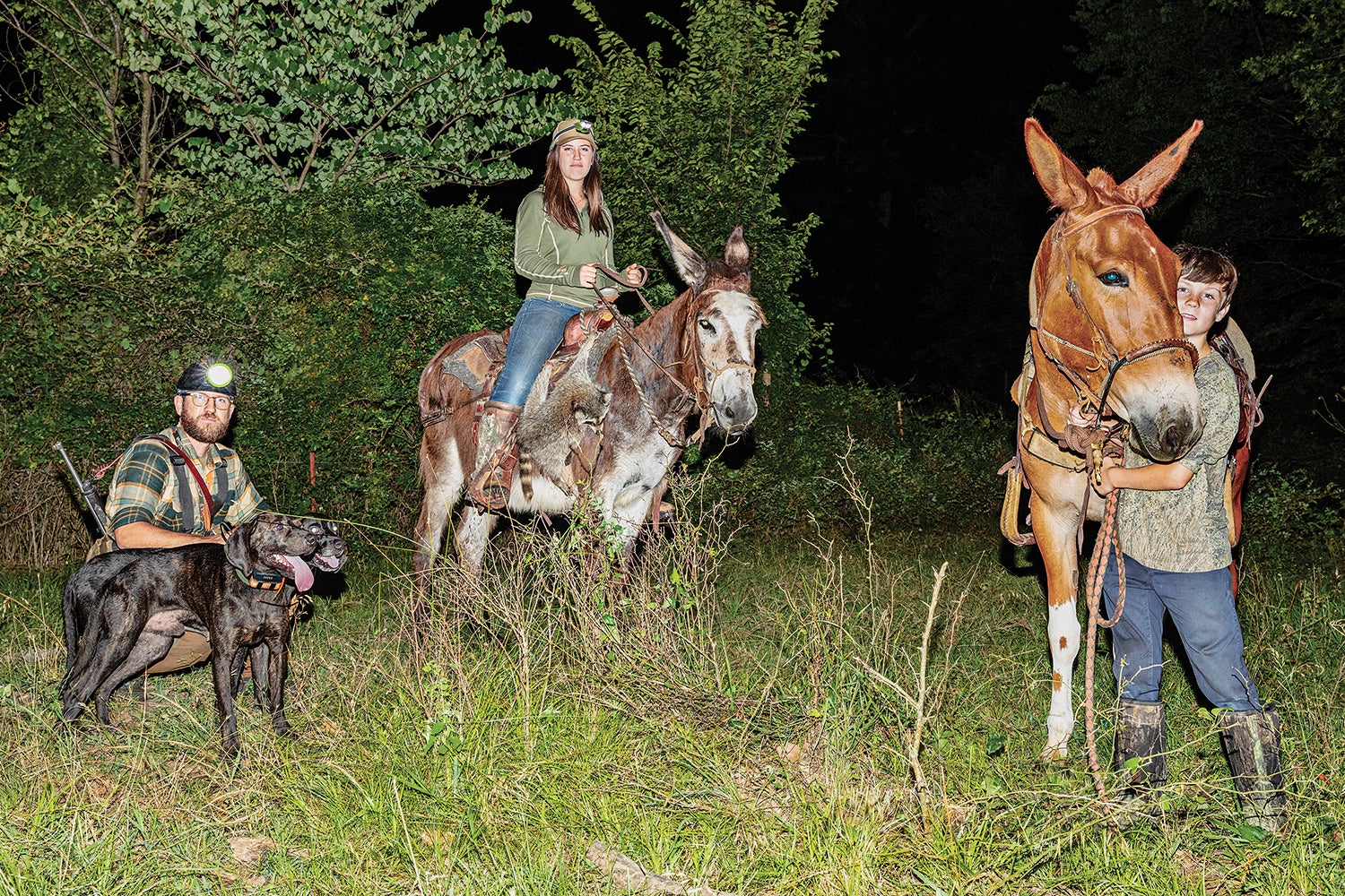 trio of hunters: man with dog, woman on donkey, boy with mule