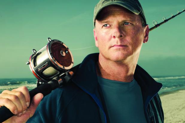 fisherman don white stands on a beach where he was attacked by a shark