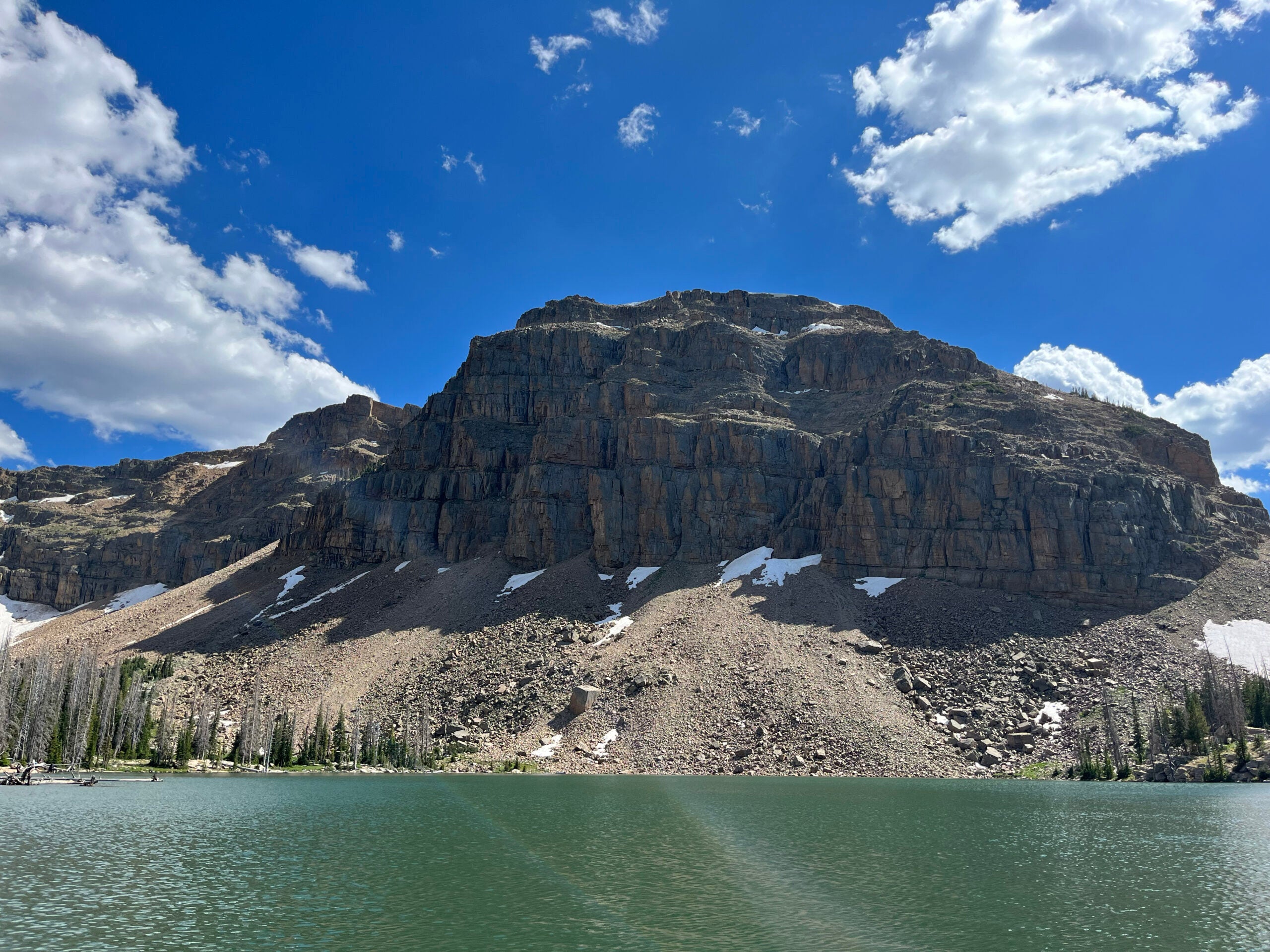 A mountain sits across a lake.