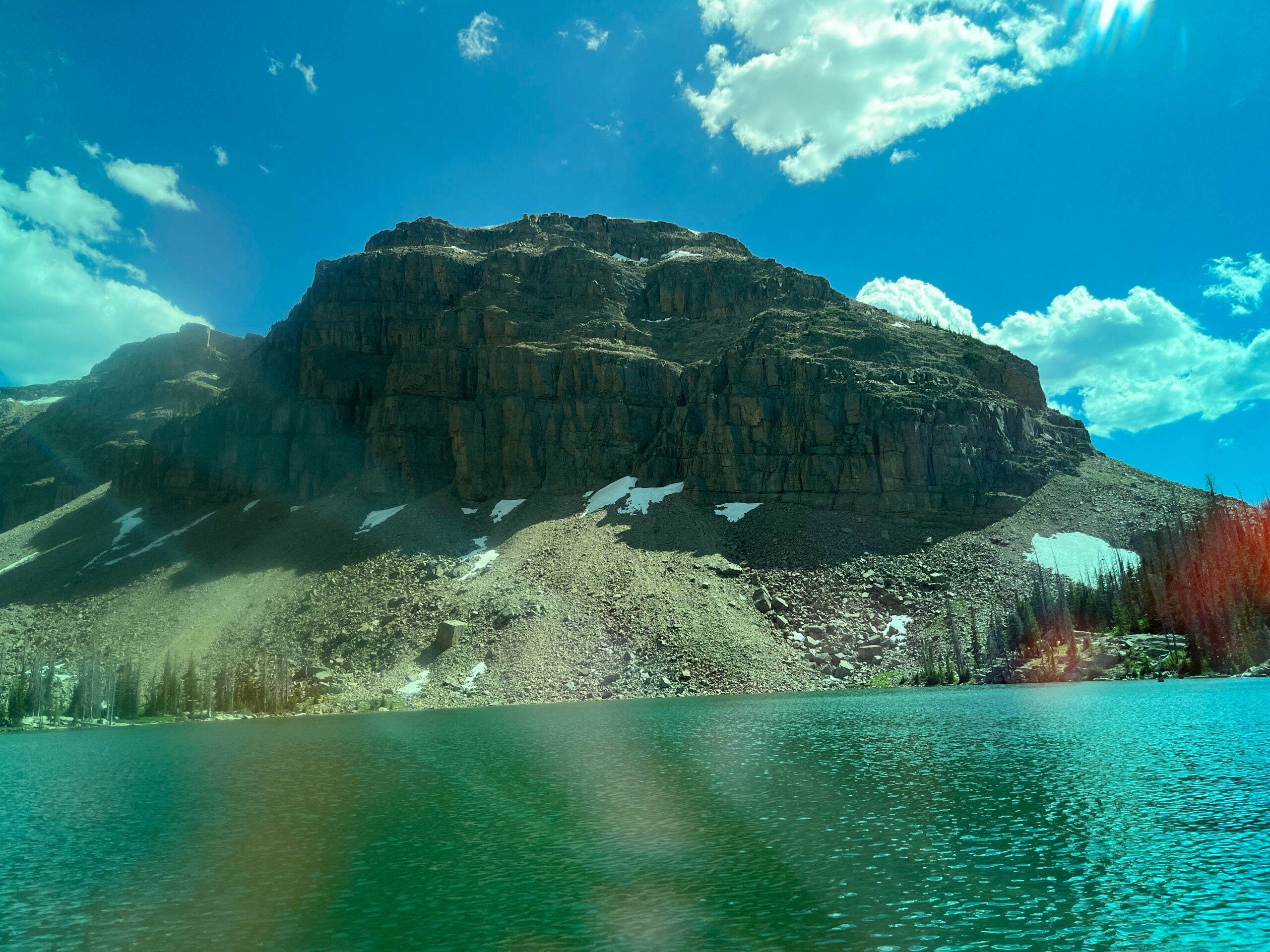 A mountain sits across a lake.