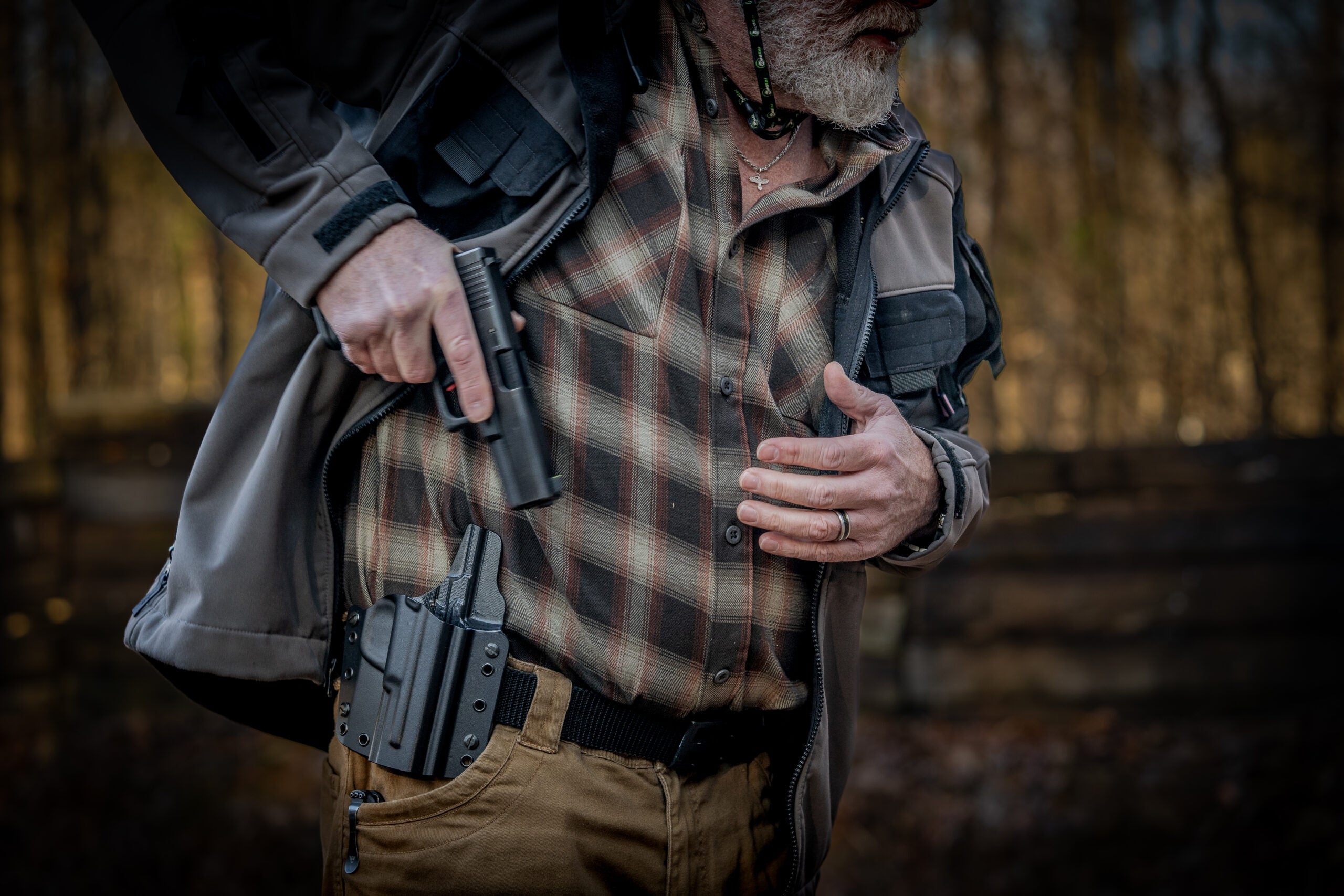 man drawing glock from holster