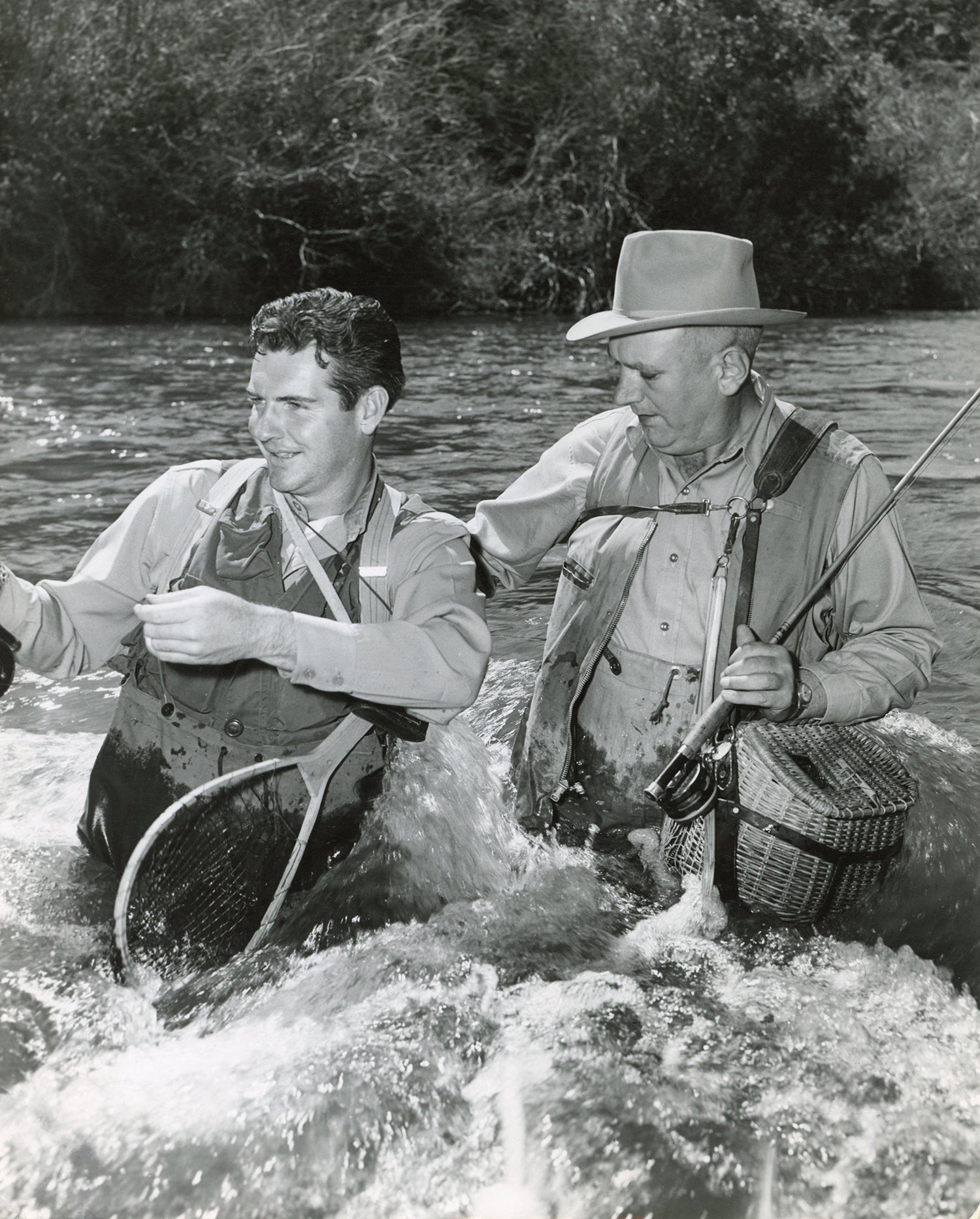 two fly anglers stand in waist-high current