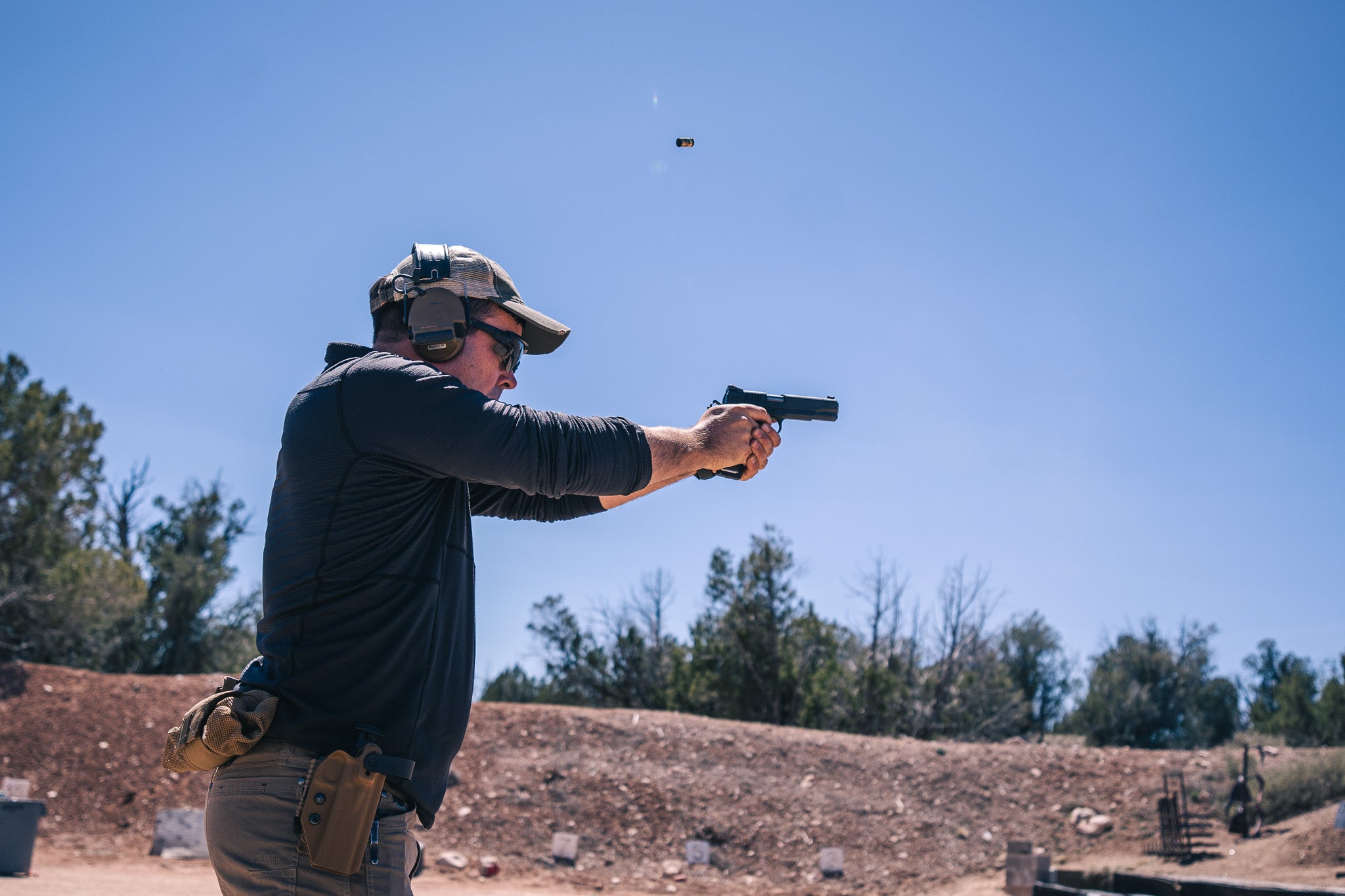 A guy practices shooting the spinner targets at the range.