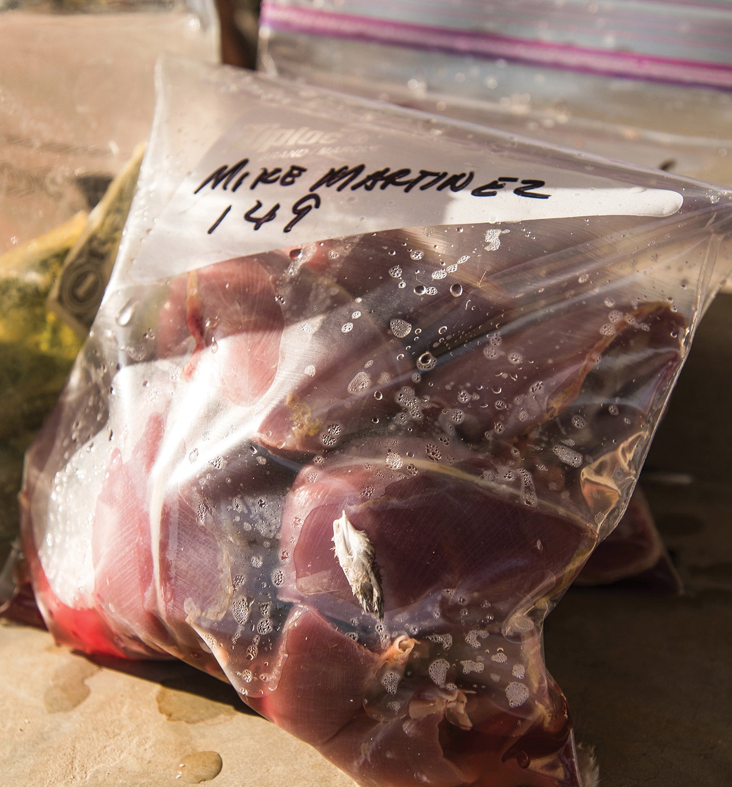 plastic bag containing dove breasts is marked with hunter's name