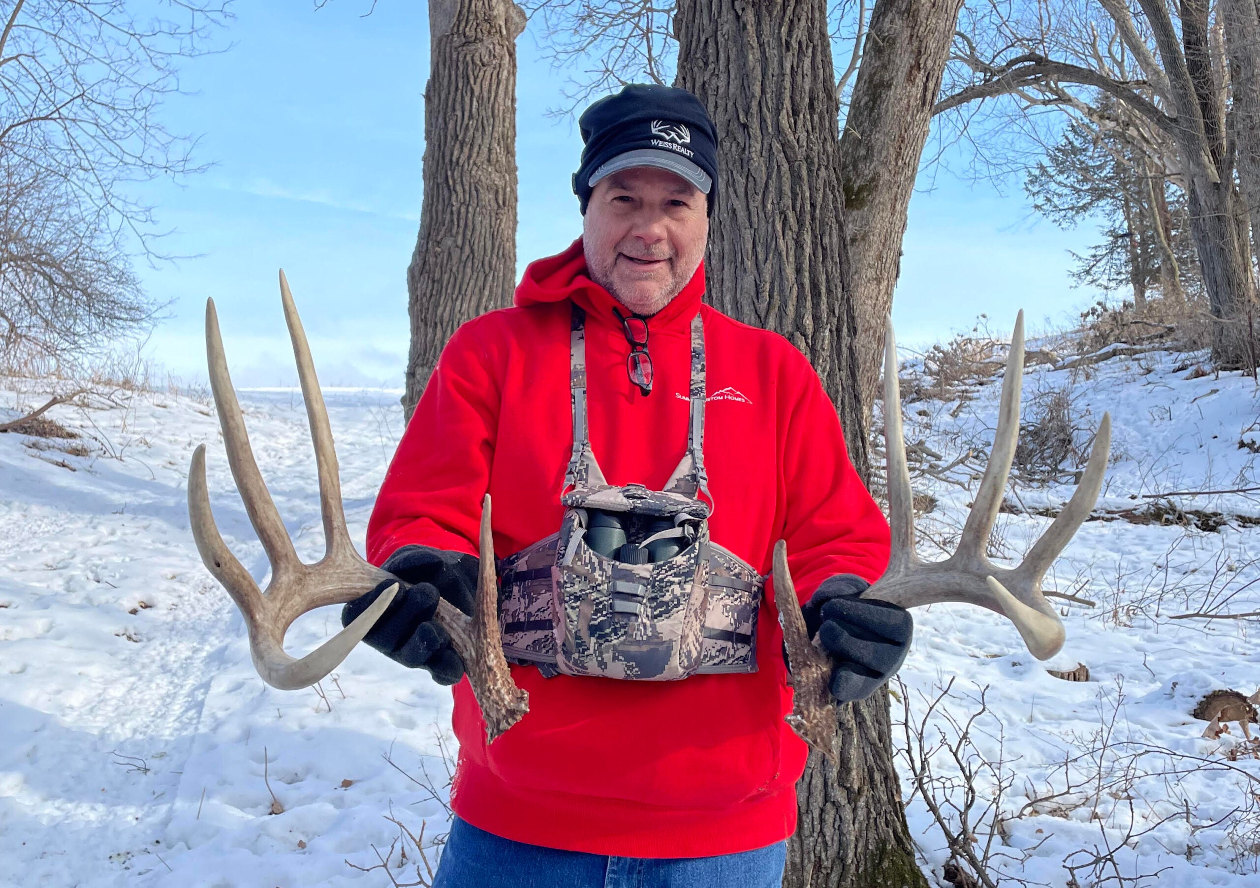 photo of the hunter showing off the matched set of shed antlers