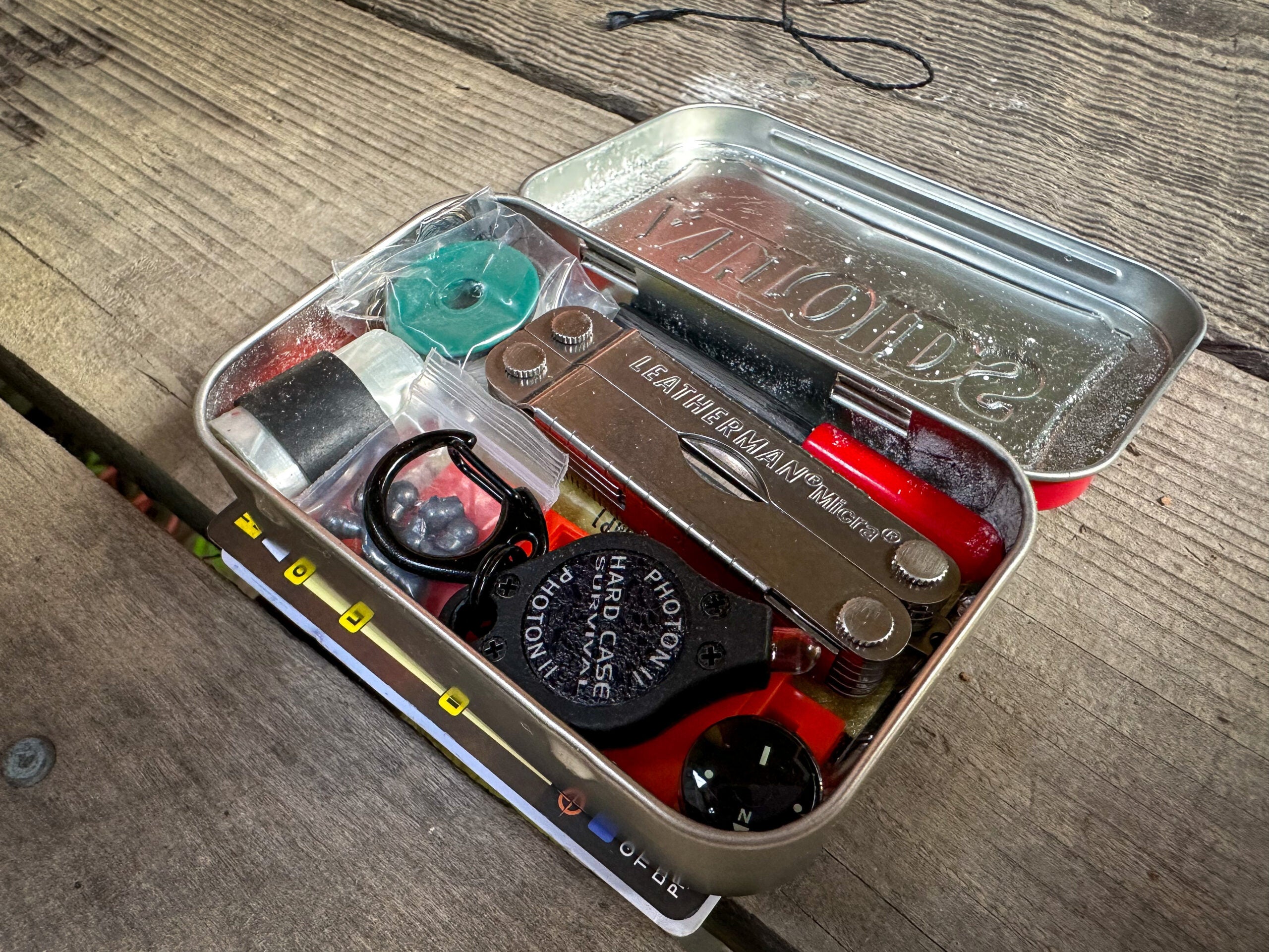 An Altoids tin full of survival gear.
