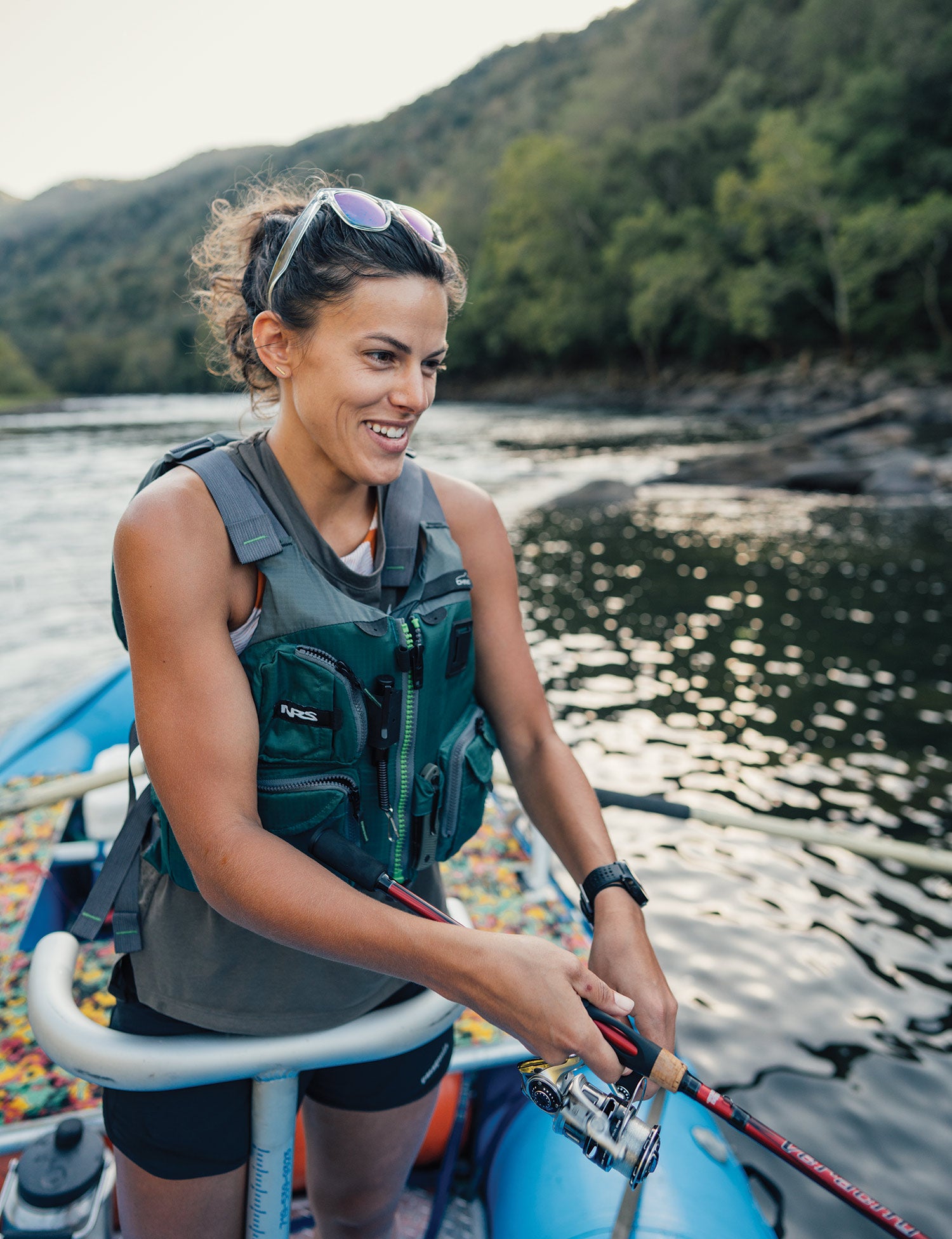 Angler leans into metal support on raft to have some support while casting.