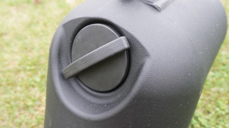 The round pressurizing cap of the Leitner HydroPod portable shower on a green grass background.