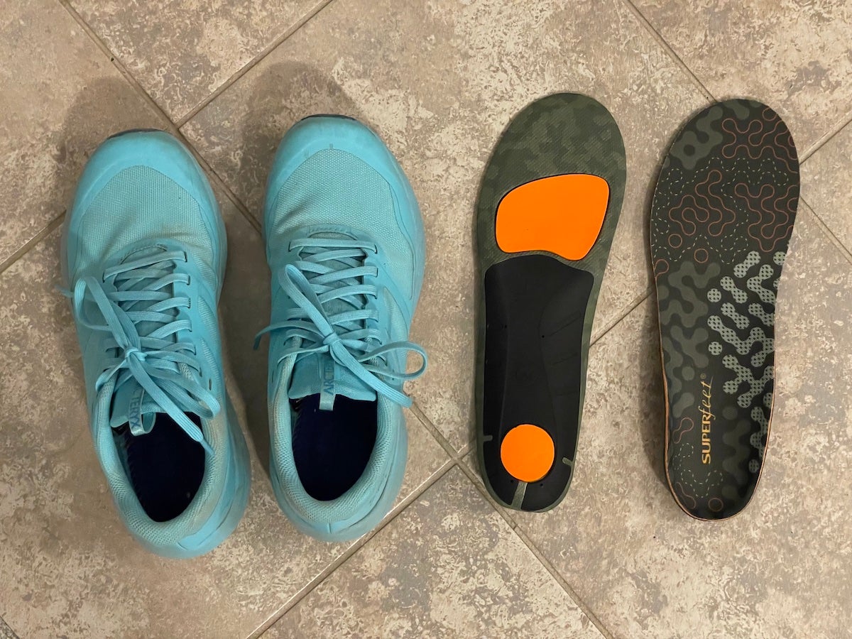 Superfeet Hike Cushion Insoles sitting next to trail running shoes
