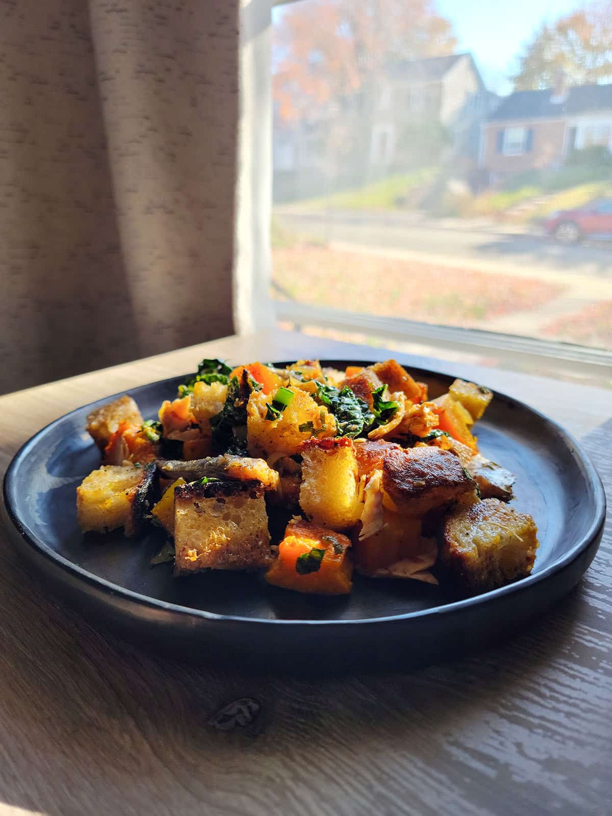 A plate of panzanella di mare in a window.