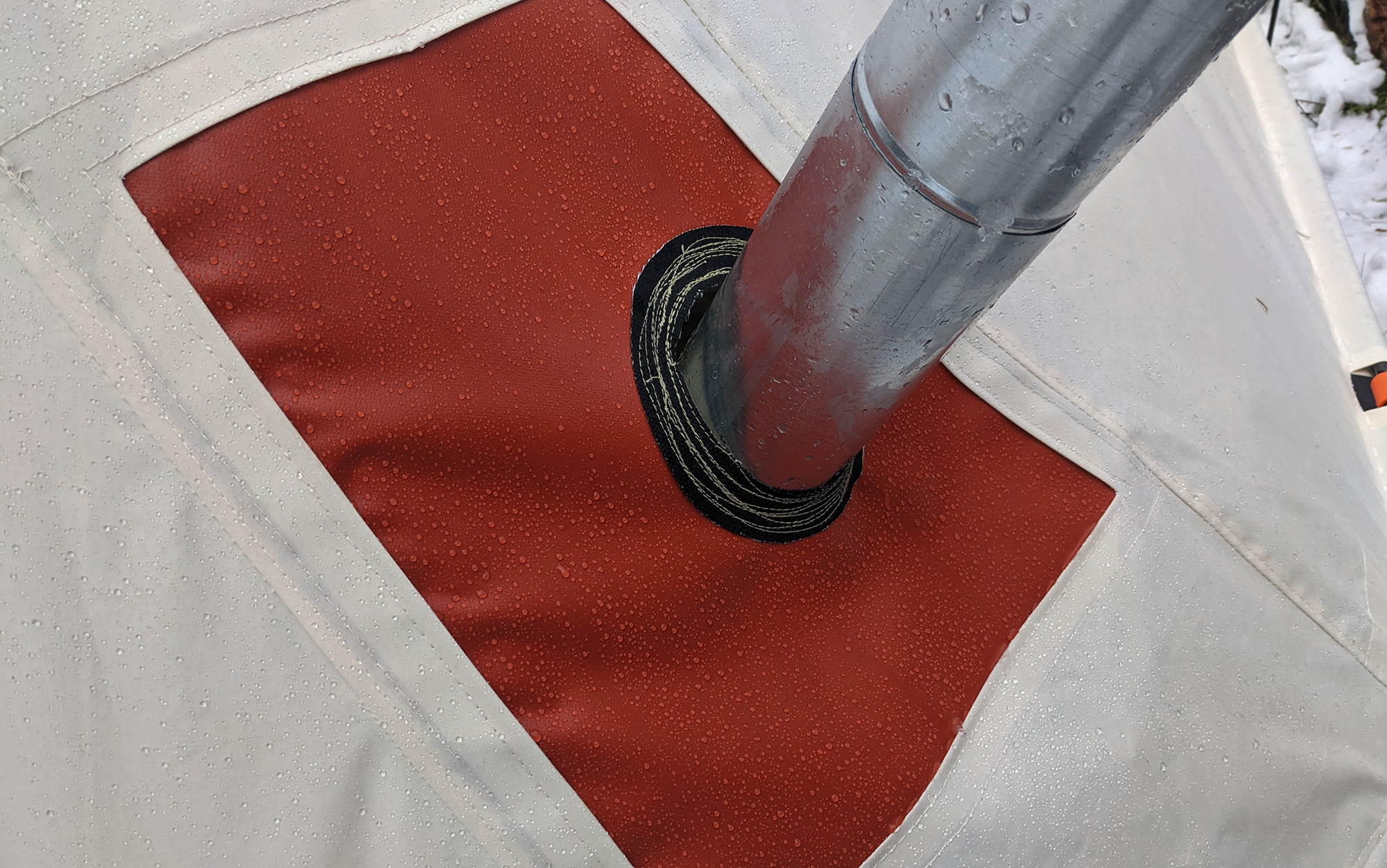 The stove pipe opening on the Snowtrekker Shortwall does, unfortunately, allow some moisture to sneak in through the caps on the sides. 