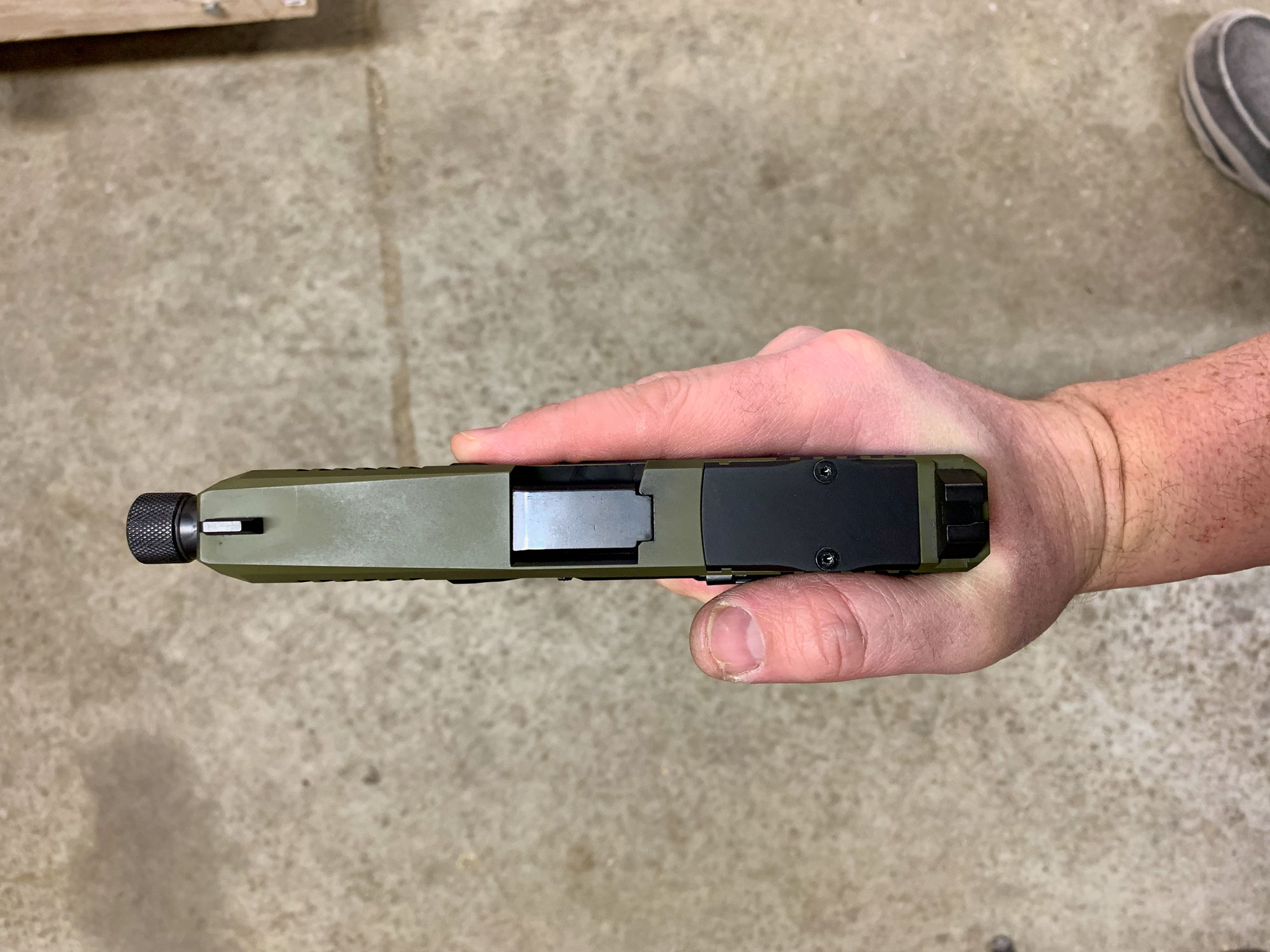 holding a pistol from above