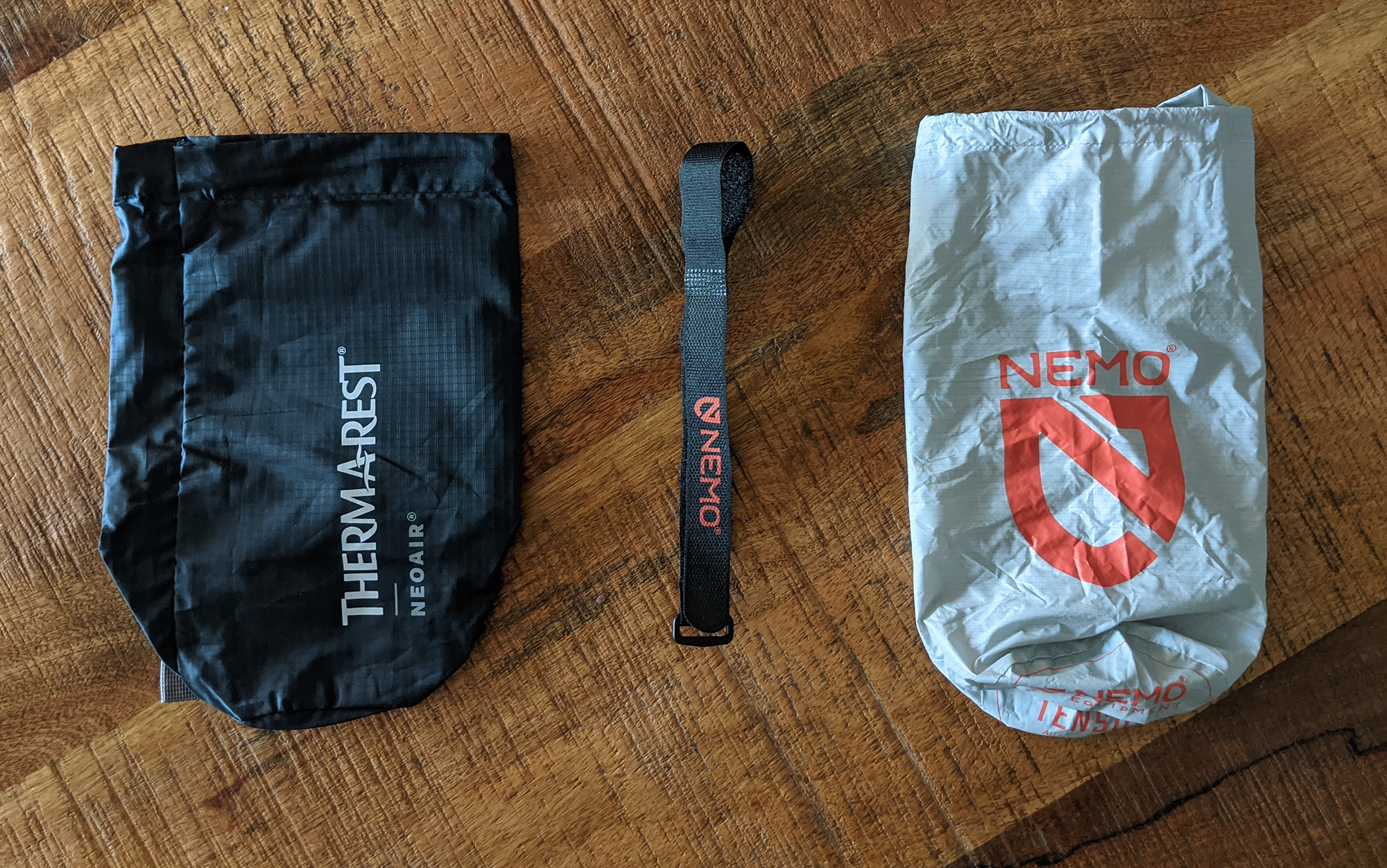 Using a velcro strap (center) to close up the Nemo Tensor is significantly easier than either of the brands’ stuff sacks.  