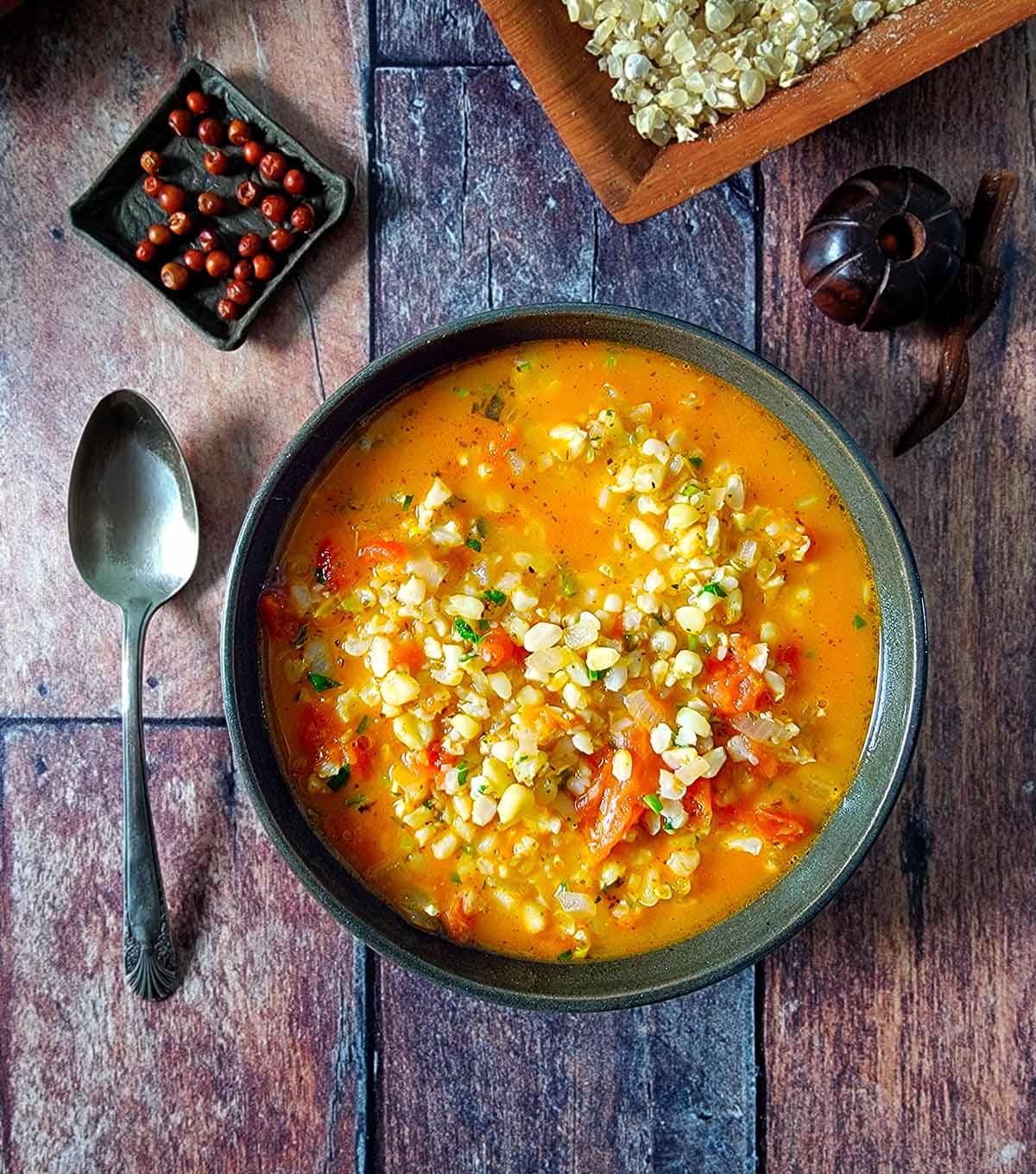 A bowl of chacales soup with all the accompaniments. 